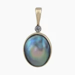 Pendant with natural oval-shaped abalone pearl from Mendocino, California measuring 12 x 9mm set in 14-karat yellow gold with a 0.03-carat VS1G quality diamond.