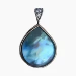 Pendant with a rare and intense, natural blue abalone pearl from Mendocino, California. Pear-shaped, measuring 13 x 12mm set in 14-karat yellow gold with a 14-karat white gold bail featuring 3 round diamonds with a TW 0.04 carats.
