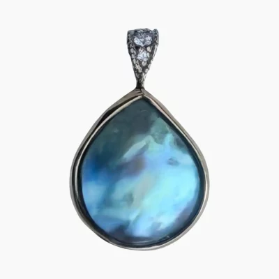 Pendant with a rare and intense, natural blue abalone pearl from Mendocino, California. Pear-shaped, measuring 13 x 12mm set in 14-karat yellow gold with a 14-karat white gold bail featuring 3 round diamonds with a TW 0.04 carats.