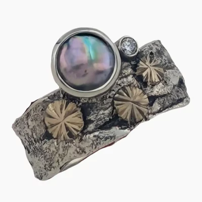 Ring with a 7mm abalone pearl from Mendocino, California set in Sterling Silver with 14-karat white gold accents and a 2mm round 0.03-carat VS1G quality accent diamond.