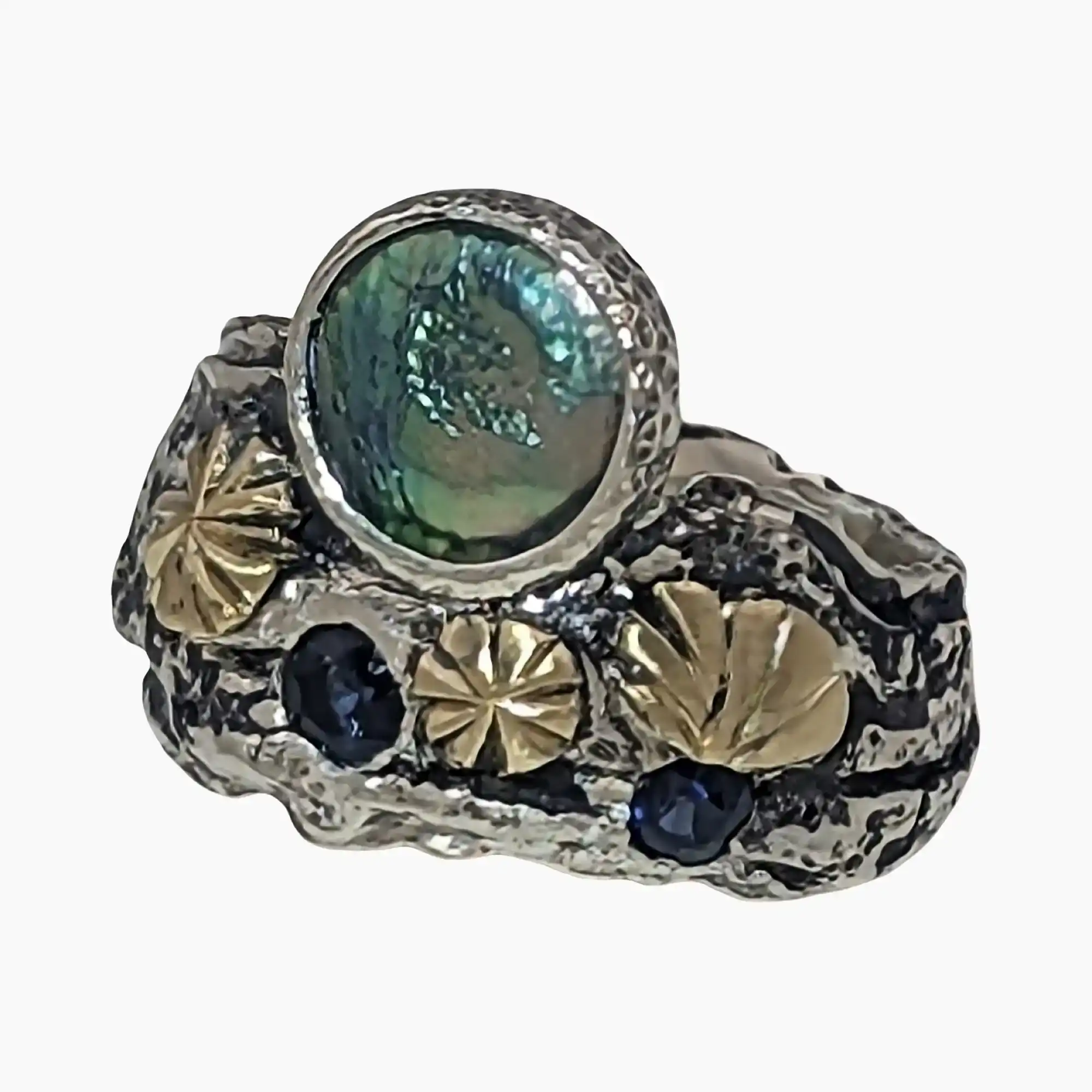 Ring with a natural abalone pearl measuring 8mm from Mendocino, California set in sterling silver with hand engraved 18-karat yellow gold accents and two round sapphires (Total weight 0.12-carats).