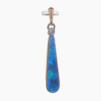 Pendant featuring a 4.35-carat long pear-shaped opal measuring 30 x 7mm from Coober Pedy, Australia. Set in solid 14-karat yellow gold and accented with a sparkling 0.10-carat VS1G diamond at the top.