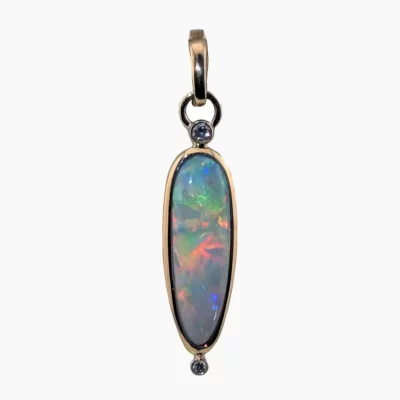 Pendant with a 2.64-carat Australian Andamooka pear-shaped opal measuring 20 x 7mm, accented with two 2.2mm round diamonds (TW) 0.07-carats set in solid 14-karat yellow gold.