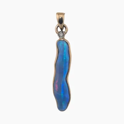 Pendant with a 2.24-carat freeform shaped opal from Coober Pedy measuring 24 x 6mm set in solid 14-karat yellow gold with a 2mm round 0.03-carat VS1G diamond accent.
