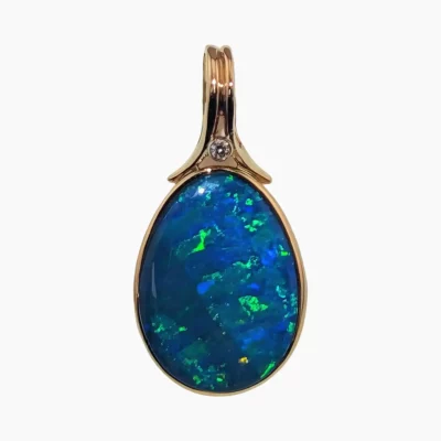 Pendant with a 3.58-carat pear-shaped opal from Coober Pedy, Australia measuring 18 x 13mm set in solid 14-karat yellow gold with a 14-karat white gold bezel containing a round 2mm 0.03 carat VS1G diamond.