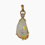 Hand fabricated 3.88-carat opal pendant from Coober Pedy, Australia. Freeform shape, measuring 17 x 9.6mm with a 0.10-carat diamond set in solid 14-karat yellow gold.