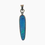 Pendant with a 1.90-carat tapered drop shaped opal from Coober Pedy, Australia measuring 24 x 6mm set in solid 14-karat yellow gold with a single 1.7mm round 0.02-carat VS1G diamond.