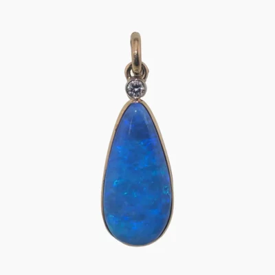 Pendant with a 6.05-carat pear-shaped opal from Coober Pedy, Australia measuring 24 x 12mm set in solid 14-karat yellow gold with a 3mm round 0.10-carat VS1G diamond accent.