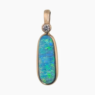 Pendant with a rare 1.77-carat oval opal from Lambina, Australia measuring 16 x 6mm set in solid 14-karat yellow gold with a 2.4mm round 0.05-carat VS1G diamond accent.