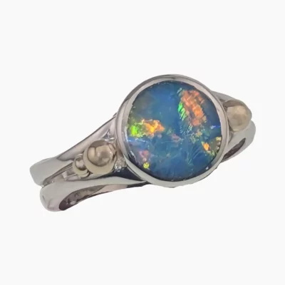 Ring featuring a round 1.77-carat opal from Lambina, Australia measuring 10mm set in sterling silver with solid 14-karat yellow gold accents.