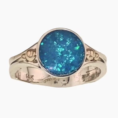 Ring with a 1.36-carat Australian Lambina opal featuring an 11mm round opal, set in sterling silver with solid 14-karat yellow gold accents.