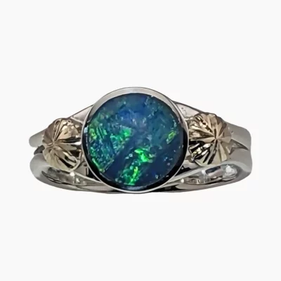 Ring with a 9mm round 1.65-carat opal from Lambina, Australia measuring 9mm set in sterling silver with hand engraved 18-karat yellow gold accents.