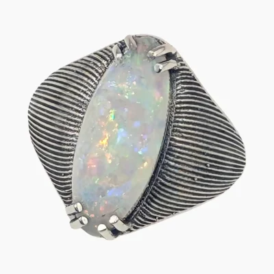 Ring featuring an oval 2.67-carat opal from Coober Pedy, Australia measuring 17.5 x 7.4mm set in sterling silver.
