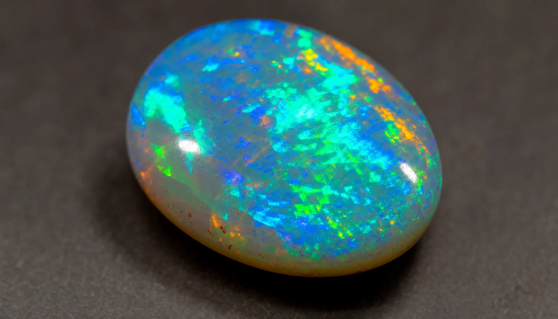 A bright opal cabochon with play-of-color, October's birthstone