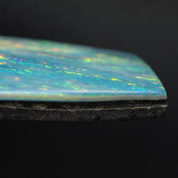 Opal doublet showing a thin opal slice glued to a dark backing layer