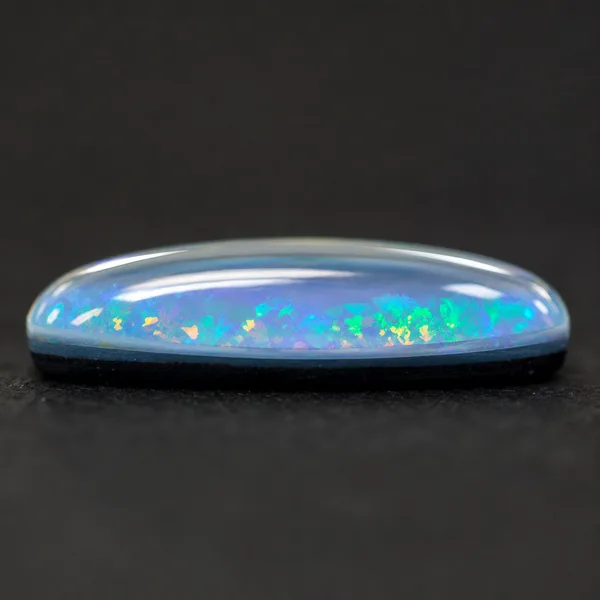 Opal triplet with a clear domed cap layered over a thin opal slice and dark backing
