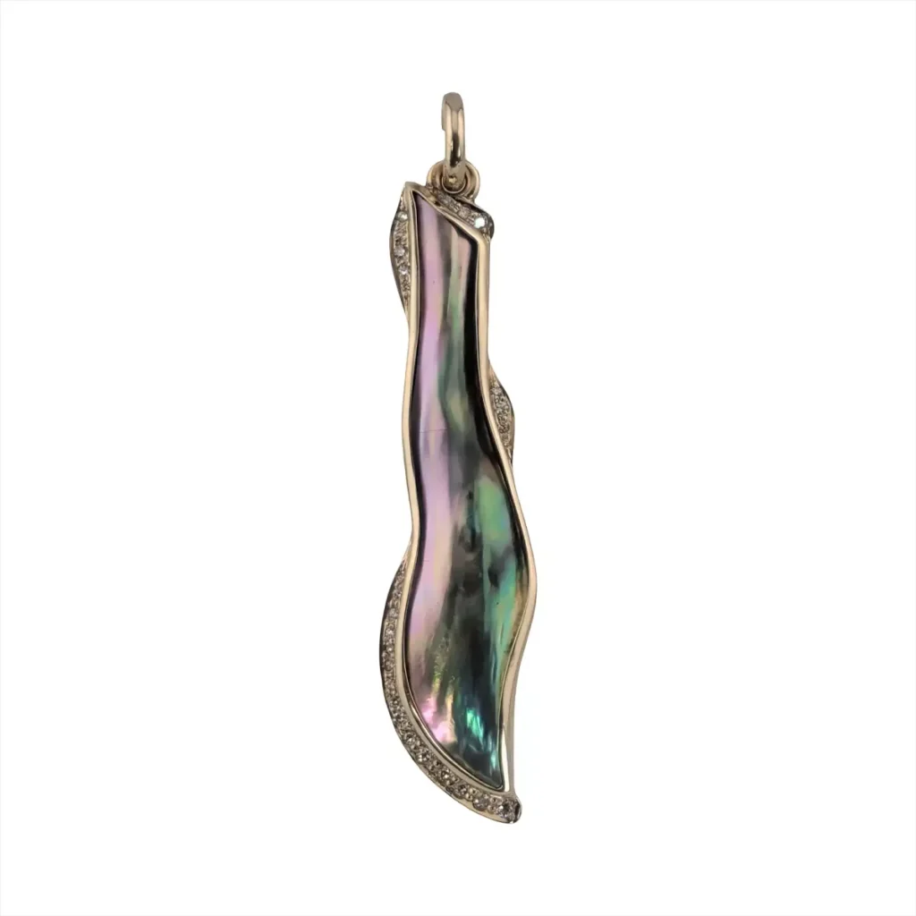 Long wavy abalone blister pearl pendant edged with pave diamonds in gold