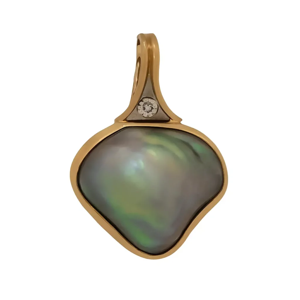 Abalone mabe pearl pendant in yellow gold with a diamond accent on the bail