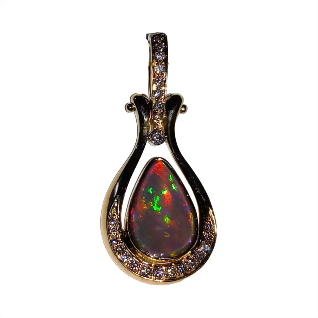 Black opal pendant with red and green fire in a diamond-set gold teardrop frame