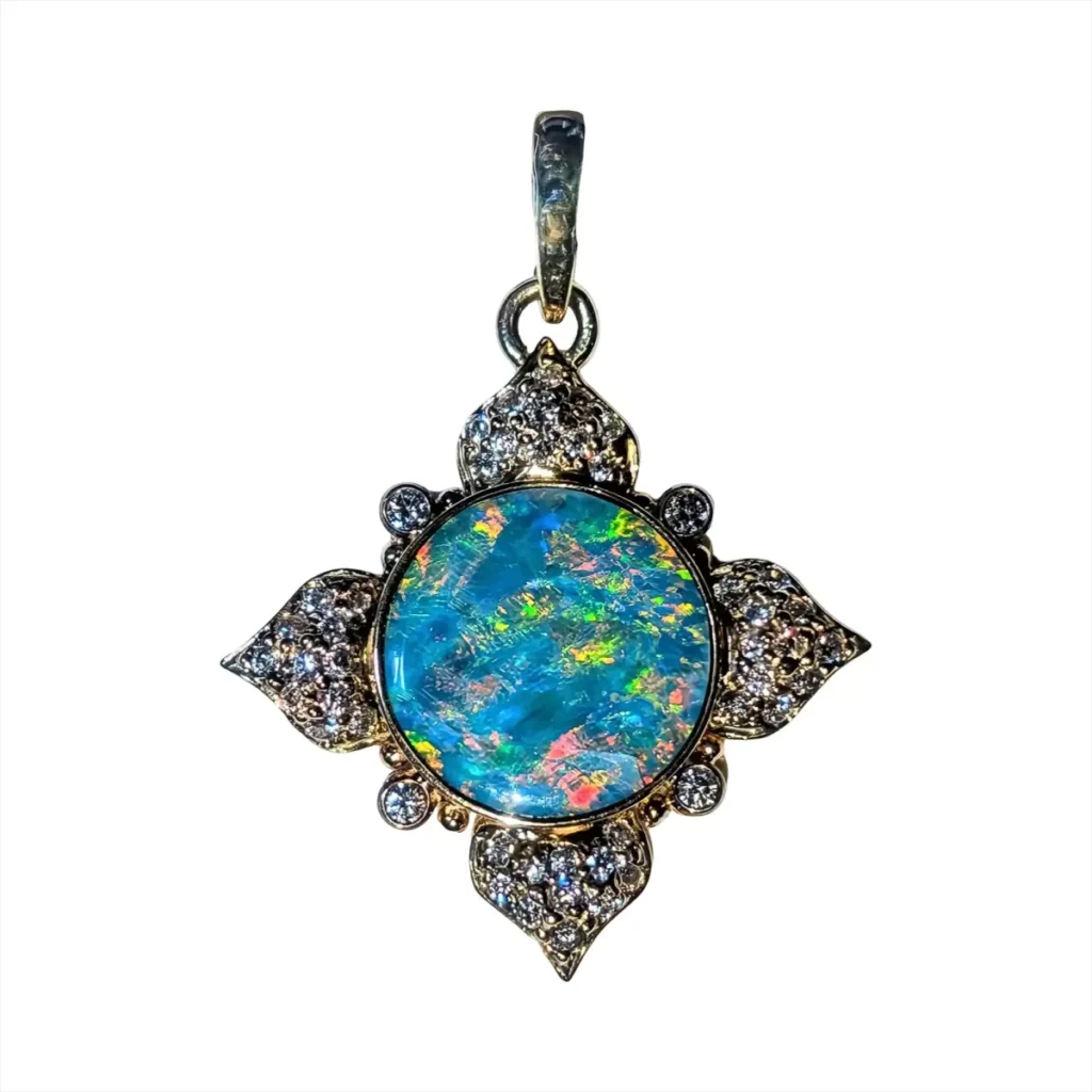 Round opal pendant in a four-point gold setting with pave diamond petals