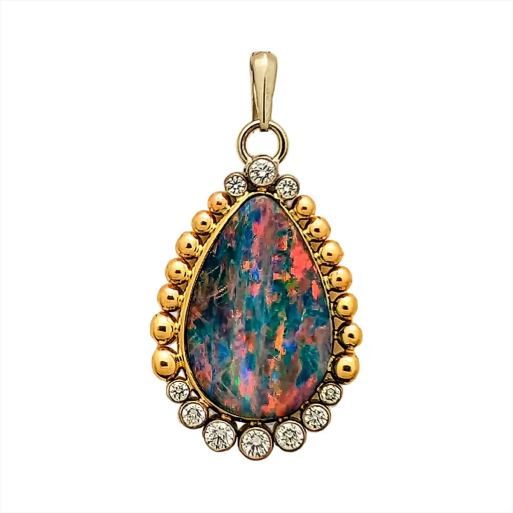 Pear-shaped opal pendant surrounded by gold beads and bezel-set diamonds