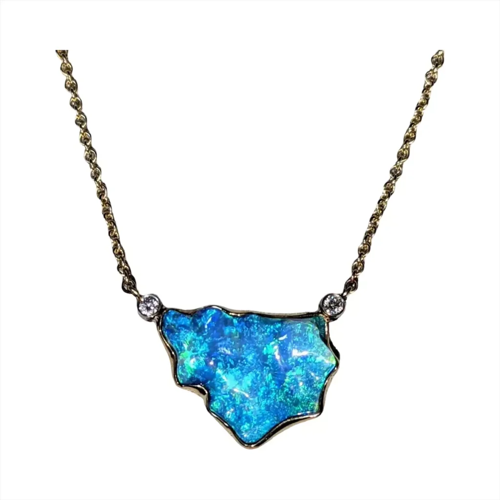 Free-form blue opal necklace with two bezel-set diamonds on a gold chain
