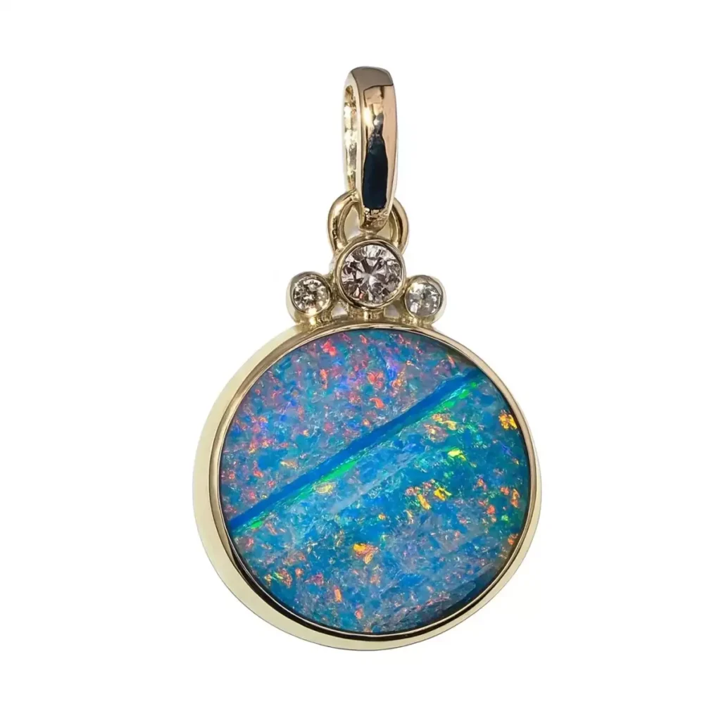 Round opal pendant in gold crowned with three bezel-set diamonds